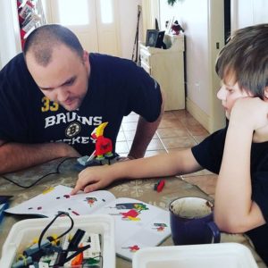 boy and dad studying together