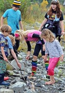 Oak Meadow kids exploring stream, navigating working and homeschooling