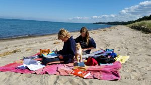 high-school-homeschoolers-studying-on-beach
