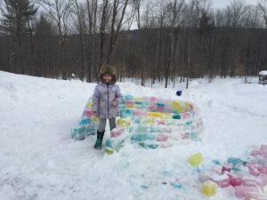 OM student with colorful ice block fort