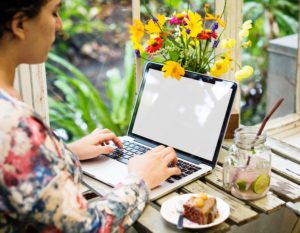 girl using laptop and flowers