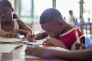 boy at desk writing