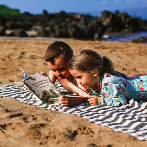 Kids reading at the beach