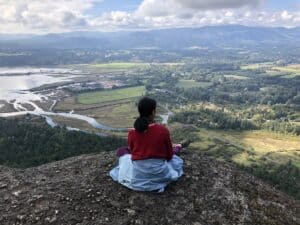 Oak Meadow student sitting and looking over valley