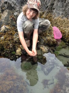 Oak Meadow middle school student looking at tidepool