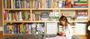 Oak Meadow distance learning student in front of bookcase
