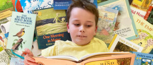 homeschool student surrounded by books