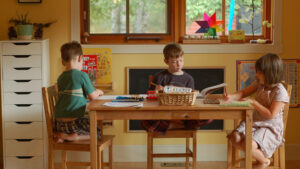 three students working at their homeschool space