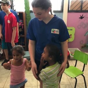 Diana Wipf holding hands with two small children