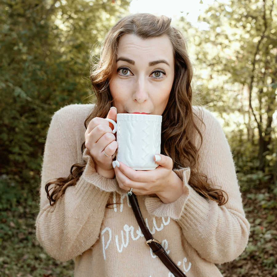 Natalie Wise holding a cup of hot cocoa