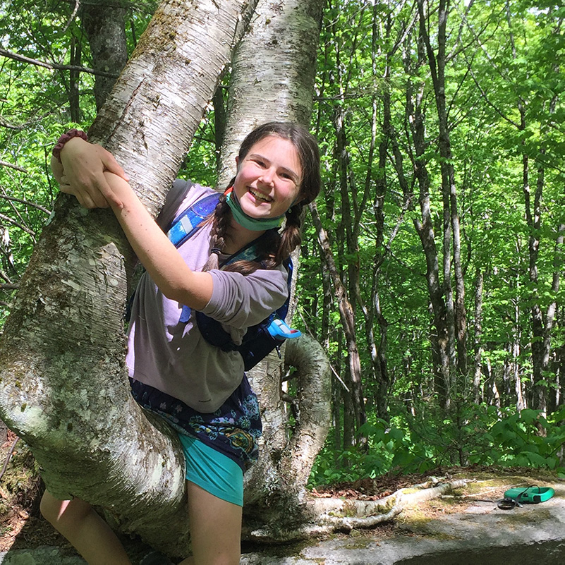 high school student climbing a tree