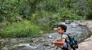 Oak Meadow homeschool student learning by local river