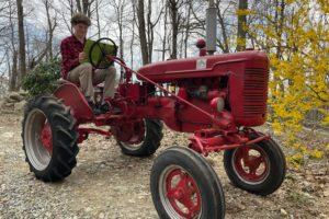 Liam McBrien driving a red tractor