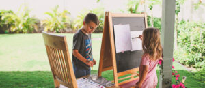 students using an easel to do school outside