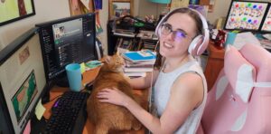Oak meadow high school student working at computer with orange cat