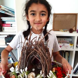 Student showing off homeschool nest project