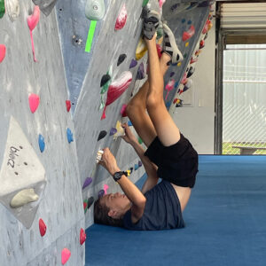 Donavon Nail climbing a rock wall upside down
