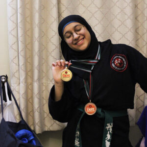Maryam Mir showing off her karate medal