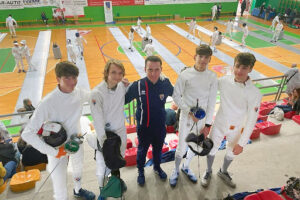 Willem Romeo Atkinson with his fencing coach and teammates