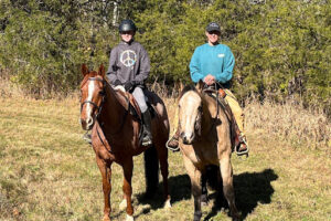 emelia thompson and a man on their horses